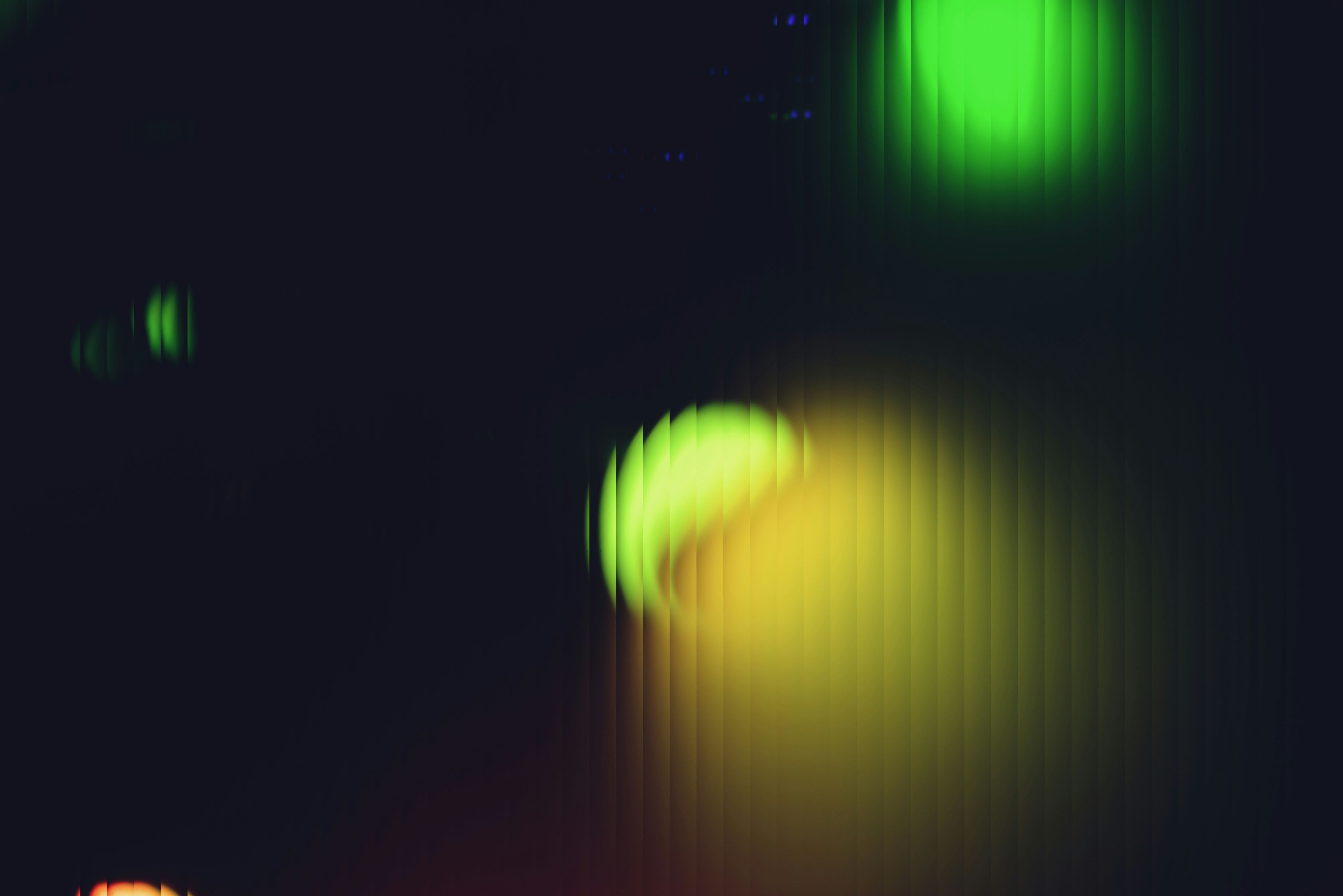 Blurred green and yellow lights on dark background